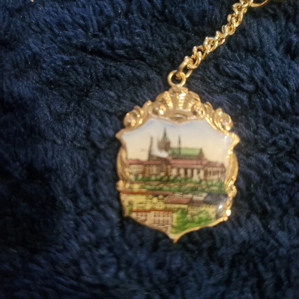 Vintage souvenir keychain a painted enamel depiction of Prague Castle
